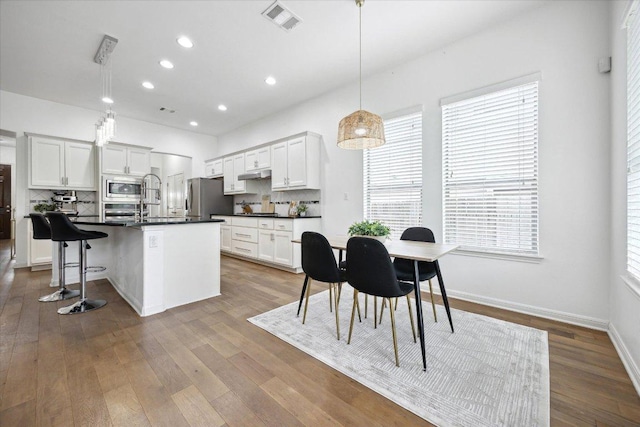 2216 Lookout Knoll Dr, Leander, TX 78641 - dining space with recessed lighting and wood finished floors