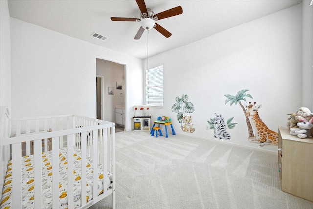 2216 Lookout Knoll Dr, Leander, TX 78641 - bedroom with light colored carpet, a crib, and a ceiling fan