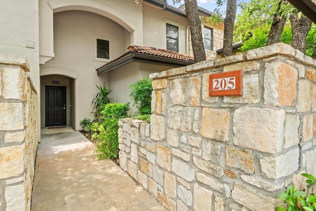 1000 Liberty Park Dr Unit 205, Austin, TX 78746 - doorway to property with stucco siding and stone siding