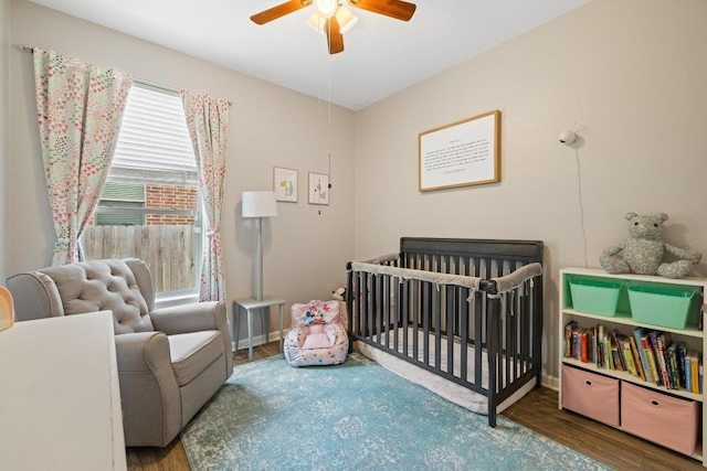 901 Water Hyacinth Loop, Leander, TX 78641 - bedroom featuring wood finished floors, a crib, and ceiling fan