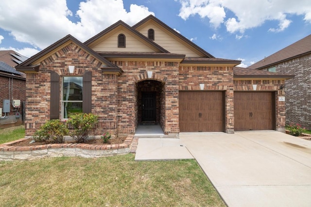 901 Water Hyacinth Loop, Leander, TX 78641 - view of front facade featuring a garage, brick siding, concrete driveway, and a front yard