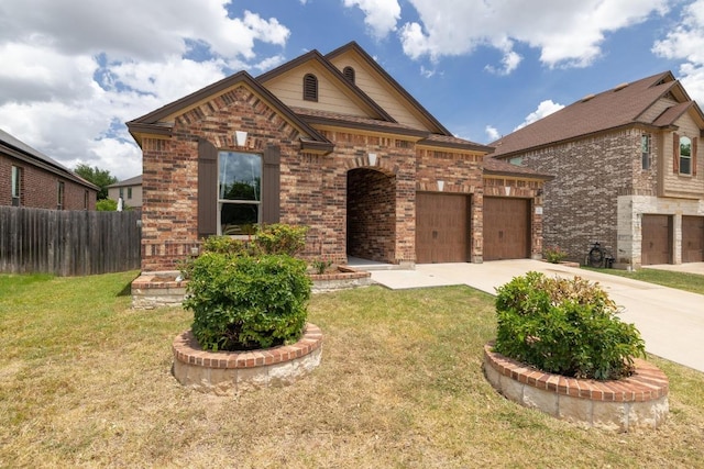 901 Water Hyacinth Loop, Leander, TX 78641 - view of front facade with brick siding, driveway, and an attached garage