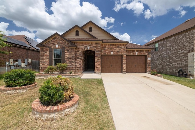 901 Water Hyacinth Loop, Leander, TX 78641 - traditional home with a garage, concrete driveway, brick siding, and a front lawn