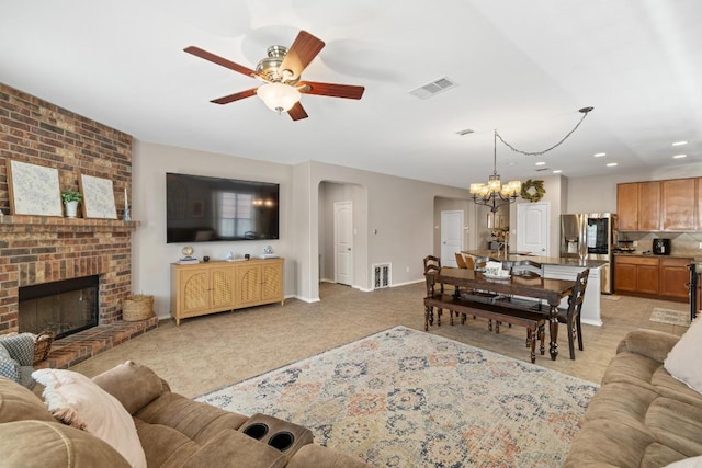 901 Water Hyacinth Loop, Leander, TX 78641 - living room with a ceiling fan, a chandelier, arched walkways, a fireplace, and recessed lighting