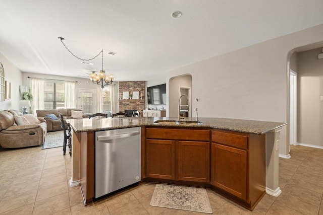 901 Water Hyacinth Loop, Leander, TX 78641 - kitchen with dishwasher, arched walkways, open floor plan, light tile patterned floors, and a center island with sink