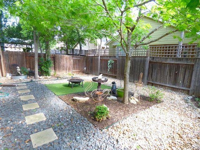 2408 Amur Dr, Austin, TX 78745 - fenced backyard featuring a fire pit