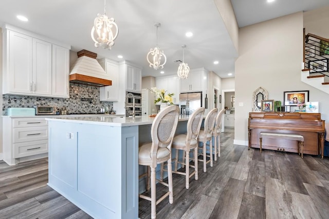633 N Stovall Dr, Robinson, TX 76706 - kitchen with a chandelier, custom range hood, a large island, light countertops, and dark wood-type flooring