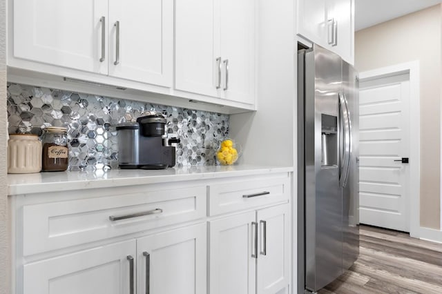 633 N Stovall Dr, Robinson, TX 76706 - bar featuring stainless steel fridge, tasteful backsplash, and light wood-style floors