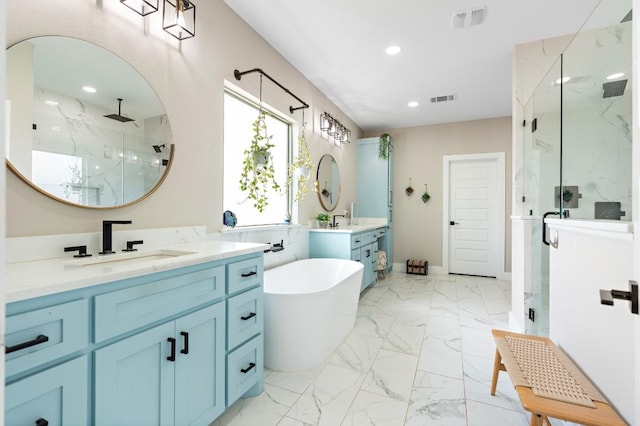 633 N Stovall Dr, Robinson, TX 76706 - full bath featuring a marble finish shower, marble look tiles, recessed lighting, two vanities, and a freestanding bath