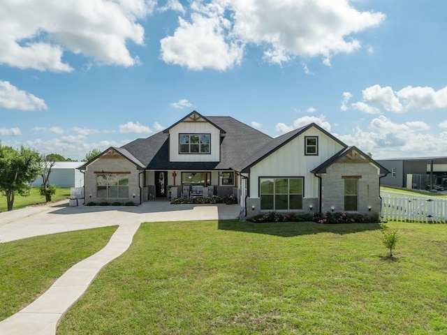 633 N Stovall Dr, Robinson, TX 76706 - back of house with board and batten siding, stone siding, a porch, and roof with shingles