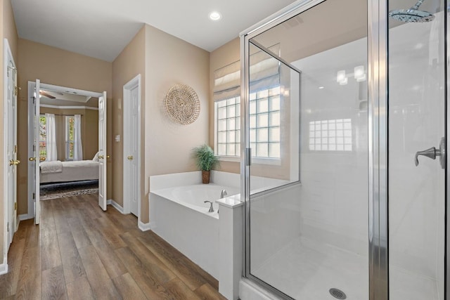 2604 Zambia Dr, Cedar Park, TX 78613 - bathroom with a garden tub, ensuite bathroom, a stall shower, and wood finished floors