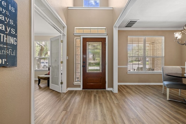 2604 Zambia Dr, Cedar Park, TX 78613 - foyer featuring a chandelier, crown molding, and wood finished floors