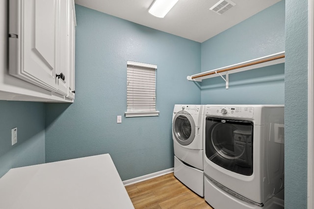 2604 Zambia Dr, Cedar Park, TX 78613 - washroom with separate washer and dryer, light wood-style floors, and cabinet space