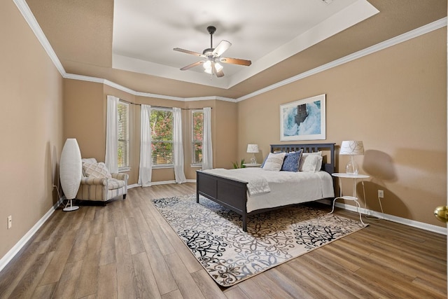 2604 Zambia Dr, Cedar Park, TX 78613 - bedroom with a tray ceiling, wood finished floors, crown molding, and ceiling fan