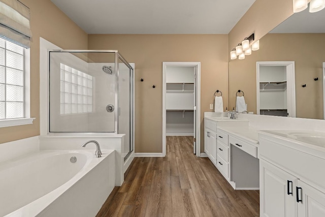 2604 Zambia Dr, Cedar Park, TX 78613 - bathroom with a walk in closet, a stall shower, double vanity, and a garden tub