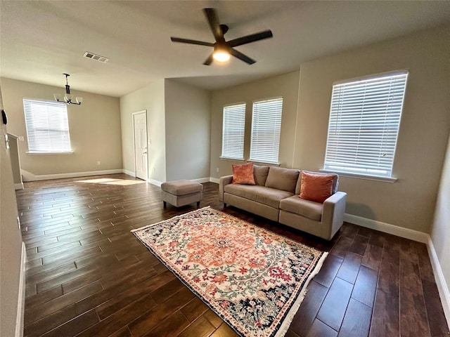 3805 E US-290 Hwy E, Paige, TX 78659 - living area with dark wood-type flooring, a ceiling fan, and a chandelier