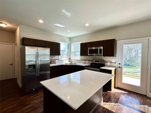 3805 E US-290 Hwy E, Paige, TX 78659 - kitchen with appliances with stainless steel finishes, dark wood-style floors, dark brown cabinets, tasteful backsplash, and recessed lighting