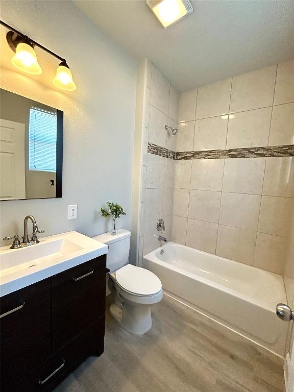 3805 E US-290 Hwy E, Paige, TX 78659 - full bath with vanity, wood finished floors, and shower / washtub combination