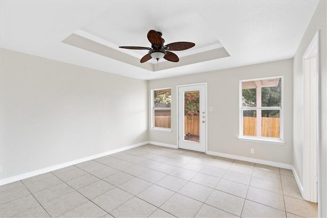 1804 Fairweather Way, Cedar Park, TX 78613 - unfurnished room featuring a raised ceiling, plenty of natural light, a ceiling fan, and light tile patterned flooring