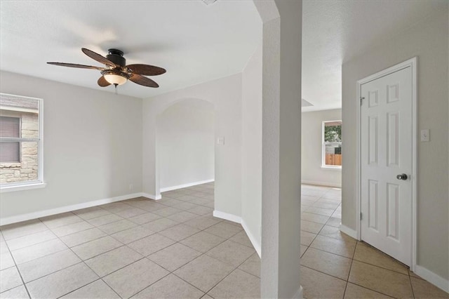 1804 Fairweather Way, Cedar Park, TX 78613 - empty room with arched walkways, ceiling fan, and light tile patterned floors
