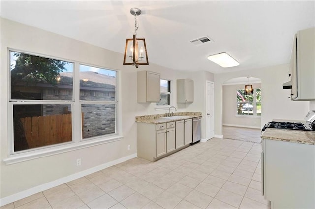1804 Fairweather Way, Cedar Park, TX 78613 - kitchen with stainless steel dishwasher, a chandelier, light tile patterned floors, arched walkways, and hanging light fixtures