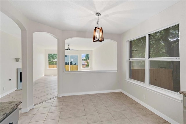 1804 Fairweather Way, Cedar Park, TX 78613 - unfurnished dining area with arched walkways, light tile patterned floors, and ceiling fan