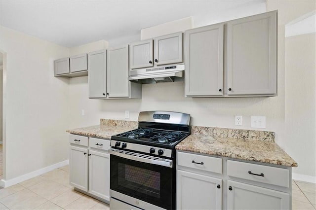 1804 Fairweather Way, Cedar Park, TX 78613 - kitchen with under cabinet range hood, stainless steel gas range, light tile patterned flooring, and light stone counters