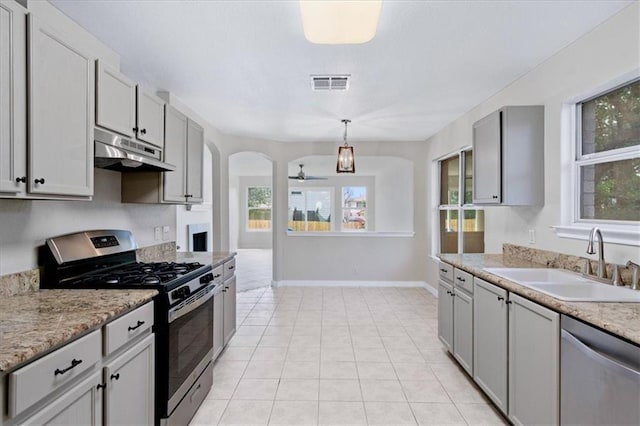 1804 Fairweather Way, Cedar Park, TX 78613 - kitchen featuring appliances with stainless steel finishes, under cabinet range hood, arched walkways, a ceiling fan, and light tile patterned floors