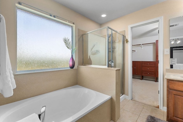 504 Hidden Brook Ln, Round Rock, TX 78665 - full bathroom with vanity, a stall shower, a bath, tile patterned floors, and a walk in closet