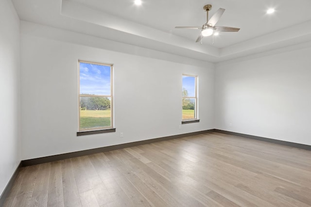 311 Out Crop, Horseshoe Bay, TX 78657 - unfurnished room featuring a raised ceiling, wood finished floors, ceiling fan, and recessed lighting