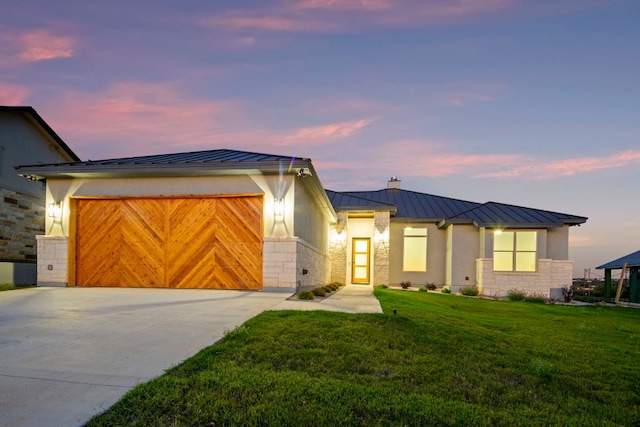 311 Out Crop, Horseshoe Bay, TX 78657 - view of front facade featuring a standing seam roof, driveway, a metal roof, a garage, and a front yard