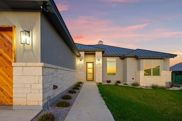311 Out Crop, Horseshoe Bay, TX 78657 - view of front of property with a standing seam roof, stucco siding, stone siding, and a yard