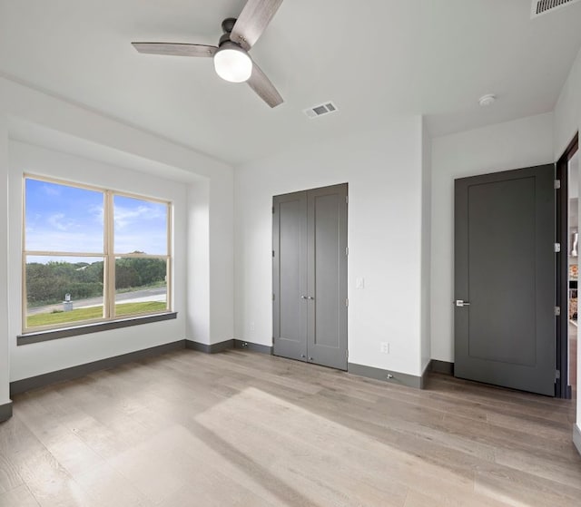 311 Out Crop, Horseshoe Bay, TX 78657 - unfurnished bedroom with light wood-style flooring and ceiling fan