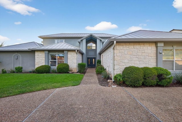 3000 Driftwood Ln, Horseshoe Bay, TX 78657 - view of front of home featuring a standing seam roof, a metal roof, stone siding, and a front yard