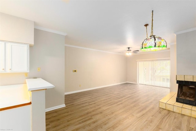 2450 Wickersham Ln Unit 1001, Austin, TX 78741 - unfurnished living room featuring a ceiling fan, crown molding, and light wood-style floors