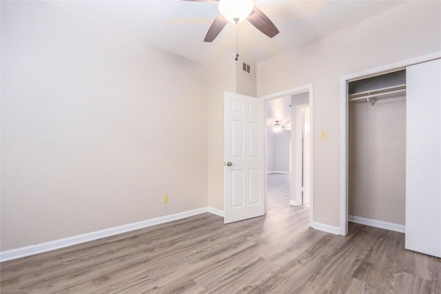2450 Wickersham Ln Unit 1001, Austin, TX 78741 - unfurnished bedroom with wood finished floors, a closet, and a ceiling fan