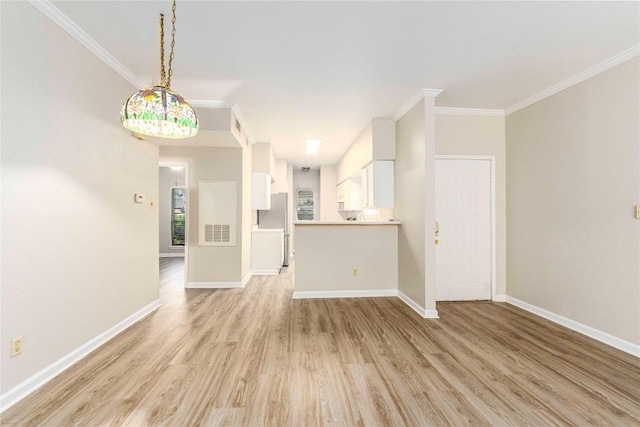 2450 Wickersham Ln Unit 1001, Austin, TX 78741 - unfurnished living room featuring light wood-type flooring and ornamental molding