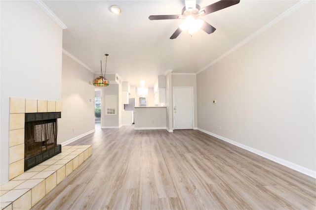 2450 Wickersham Ln Unit 1001, Austin, TX 78741 - unfurnished living room featuring light wood-style flooring, a fireplace, ceiling fan, and ornamental molding