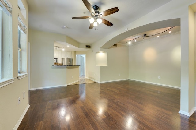 9525 N Capital Of Texas Hwy Unit 414, Austin, TX 78759 - unfurnished living room with ceiling fan, track lighting, arched walkways, and hardwood / wood-style floors