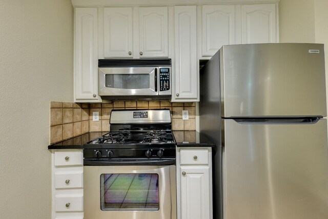 9525 N Capital Of Texas Hwy Unit 414, Austin, TX 78759 - kitchen featuring appliances with stainless steel finishes, dark countertops, decorative backsplash, and white cabinetry