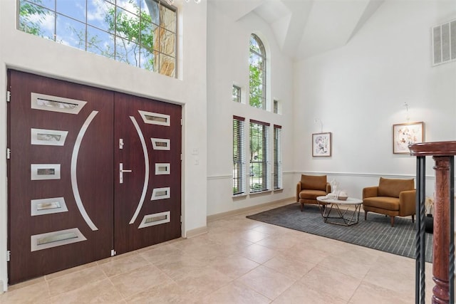 7608 Journeyville Dr, Austin, TX 78735 - foyer featuring a towering ceiling, plenty of natural light, and light tile patterned floors