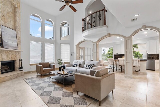 7608 Journeyville Dr, Austin, TX 78735 - living area with a ceiling fan, light tile patterned flooring, a fireplace, a high ceiling, and recessed lighting