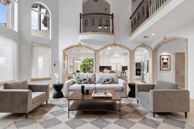 7608 Journeyville Dr, Austin, TX 78735 - living area featuring a high ceiling, arched walkways, and ornate columns