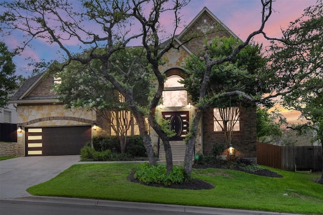 7608 Journeyville Dr, Austin, TX 78735 - view of front facade with concrete driveway, stone siding, and an attached garage