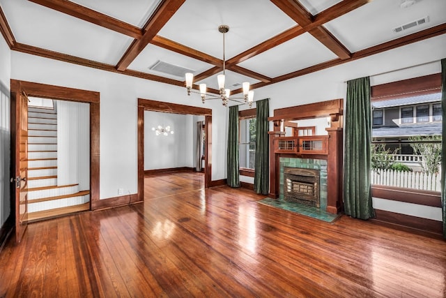 1806 S Main St, Georgetown, TX 78626 - unfurnished living room with a chandelier, coffered ceiling, wood-type flooring, a fireplace with flush hearth, and beam ceiling