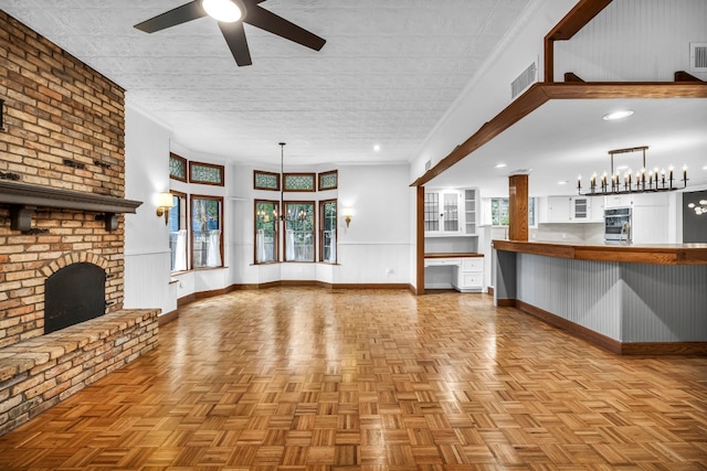 1806 S Main St, Georgetown, TX 78626 - unfurnished living room featuring healthy amount of natural light, a ceiling fan, a brick fireplace, and ornamental molding