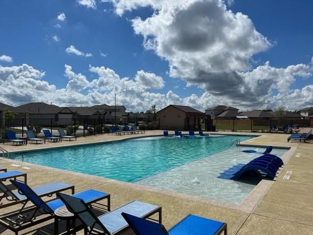 303 Watercourse Way, Bastrop, TX 78602 - community pool featuring a patio area and a residential view
