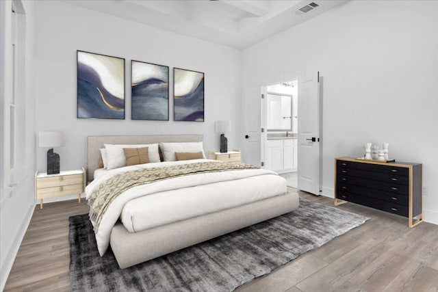 8609 San Giano Cv, Round Rock, TX 78665 - bedroom featuring wood finished floors and ensuite bath