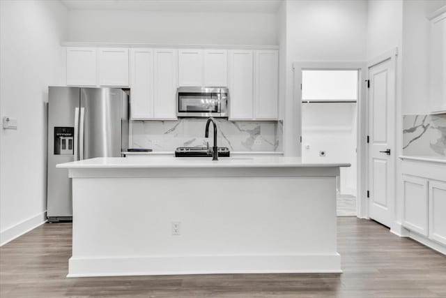 8609 San Giano Cv, Round Rock, TX 78665 - kitchen with stainless steel appliances, tasteful backsplash, and white cabinets