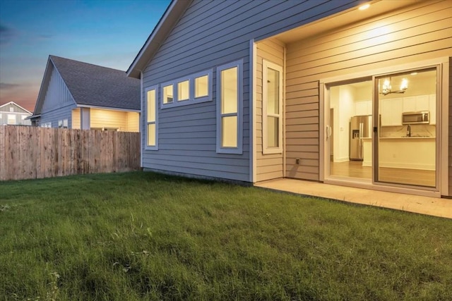 8609 San Giano Cv, Round Rock, TX 78665 - view of back of property at dusk